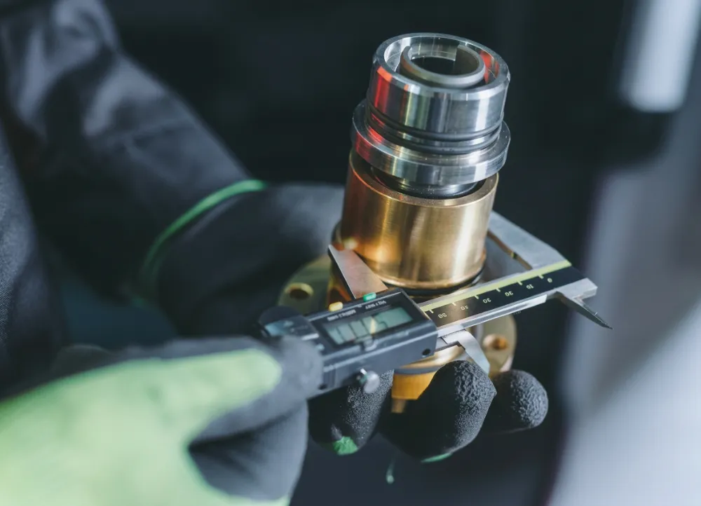 Quality inspector measuring a machined part